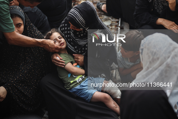 Mourners are reacting during the funeral of Palestinians killed in Israeli strikes, amid the Israel-Hamas conflict, at Al-Aqsa hospital in D...