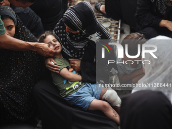 Mourners are reacting during the funeral of Palestinians killed in Israeli strikes, amid the Israel-Hamas conflict, at Al-Aqsa hospital in D...