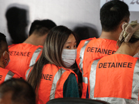 Indonesian immigration authorities are showing a group of detained Taiwan nationals during a press conference at the Immigration Detention H...