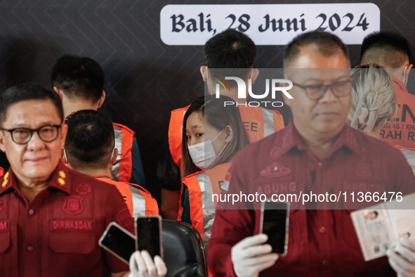 Indonesian immigration authorities are showing a group of detained Taiwan nationals during a press conference at the Immigration Detention H...