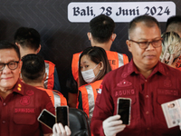 Indonesian immigration authorities are showing a group of detained Taiwan nationals during a press conference at the Immigration Detention H...