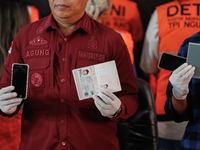 Indonesian immigration authorities are showing handphones and a Taiwan national passport during a press conference at the Immigration Detent...