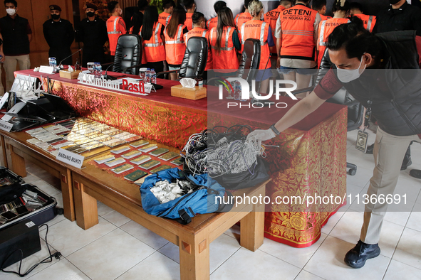 Indonesian immigration authorities are showing evidence during a press conference at the Immigration Detention House in Jimbaran, Bali, Indo...