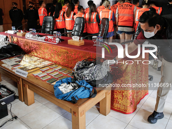 Indonesian immigration authorities are showing evidence during a press conference at the Immigration Detention House in Jimbaran, Bali, Indo...