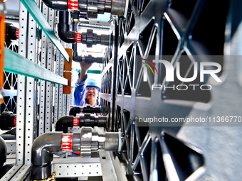 Technicians are checking the installation of energy storage equipment at the construction site of Energy Technology's 250MW/1000MWh independ...