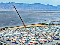 Builders are hoisting auxiliary equipment of the all-vanadium flow battery energy storage system at the site of Source Energy Technology's 2...