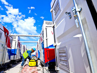 Builders are installing auxiliary equipment of the vanadium flow battery energy storage system at the site of Source Energy Technology's 250...