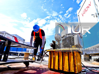 Builders are installing auxiliary equipment of the vanadium flow battery energy storage system at the site of Source Energy Technology's 250...