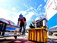 Builders are installing auxiliary equipment of the vanadium flow battery energy storage system at the site of Source Energy Technology's 250...