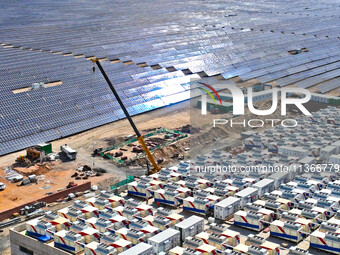 Builders are hoisting auxiliary equipment of the all-vanadium flow battery energy storage system at the site of Source Energy Technology's 2...