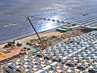 Builders are hoisting auxiliary equipment of the all-vanadium flow battery energy storage system at the site of Source Energy Technology's 2...