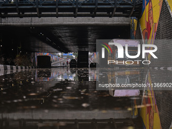 Vehicles are being seen submerged on a flooded road after heavy rains in New Delhi, India, on June 28, 2024. (