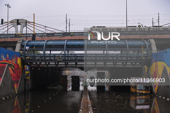 Vehicles are being seen submerged on a flooded road after heavy rains in New Delhi, India, on June 28, 2024. 