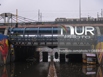 Vehicles are being seen submerged on a flooded road after heavy rains in New Delhi, India, on June 28, 2024. (