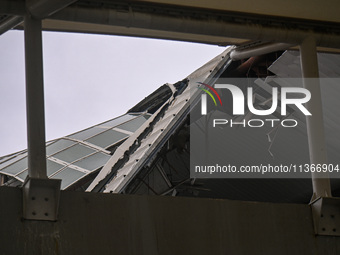 A portion of a damaged canopy is being seen at Terminal 1 of the Indira Gandhi International Airport after heavy rains in New Delhi, India,...