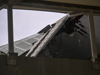 A portion of a damaged canopy is being seen at Terminal 1 of the Indira Gandhi International Airport after heavy rains in New Delhi, India,...