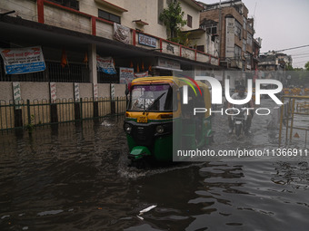 An autorickshaw is wading through a flooded street after heavy rains in New Delhi, India, on June 28, 2024. (