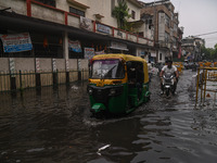 An autorickshaw is wading through a flooded street after heavy rains in New Delhi, India, on June 28, 2024. (