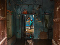 Unnati Prakash, 42, is standing inside her room as she is showing her house that was flooded with water after heavy rains in New Delhi, Indi...