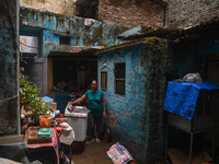 Unnati Prakash, 42, is standing inside her room as she is showing her house that was flooded with water after heavy rains in New Delhi, Indi...