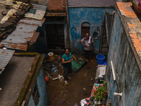 Unnati Prakash, 42, is standing inside her room as she is showing her house that was flooded with water after heavy rains in New Delhi, Indi...