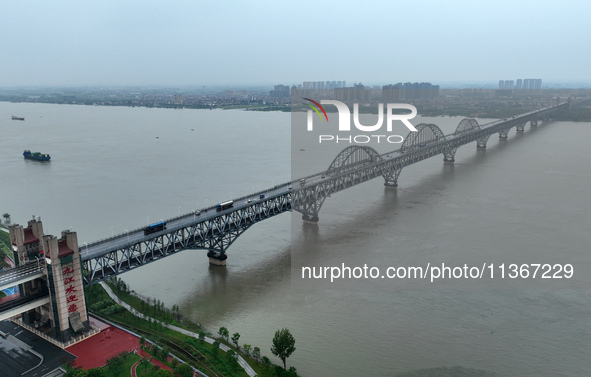 The Jiujiang Yangtze River Bridge is being seen at high water level in Jiujiang, China, on June 28, 2024. The water level at Jiujiang Statio...