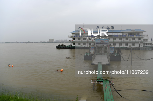 Citizens are swimming in the high water level of the Yangtze River in Jiujiang, China, on June 28, 2024. The water level at Jiujiang Station...