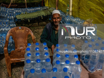 Ghulam Mohammad, 78, a Kashmiri Muslim vendor, is selling water bottles to Amarnath Pilgrims inside Nunwan Basecamp in Pahalgam, Jammu and K...