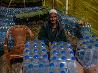 Ghulam Mohammad, 78, a Kashmiri Muslim vendor, is selling water bottles to Amarnath Pilgrims inside Nunwan Basecamp in Pahalgam, Jammu and K...