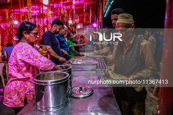 Hindus and Muslims are eating from a free food camp inside Nunwan basecamp ahead of Amarnath Cave Yatra in Pahalgam, Jammu and Kashmir, Indi...