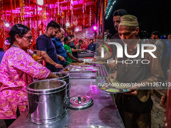 Hindus and Muslims are eating from a free food camp inside Nunwan basecamp ahead of Amarnath Cave Yatra in Pahalgam, Jammu and Kashmir, Indi...