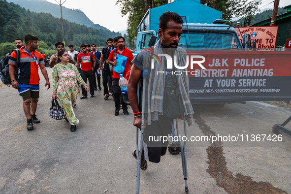 Devotees are walking towards Nunwan Basecamp where the first group of pilgrims is leaving for Amarnath Cave in Pahalgam, Jammu and Kashmir,...