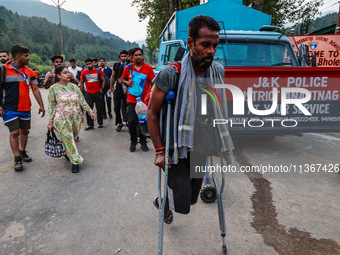 Devotees are walking towards Nunwan Basecamp where the first group of pilgrims is leaving for Amarnath Cave in Pahalgam, Jammu and Kashmir,...