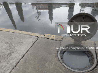 A sieve is sitting outside a flooded shopping plaza in Ecatepec, State of Mexico, as a result of the rains during the last few days. (