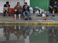 Families are standing outside their flooded homes in Ecatepec, State of Mexico, as a result of the rains during the last few days. (