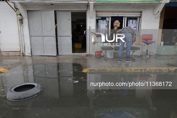 Families are standing outside their flooded homes in Ecatepec, State of Mexico, as a result of the rains during the last few days. 