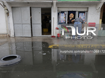 Families are standing outside their flooded homes in Ecatepec, State of Mexico, as a result of the rains during the last few days. (