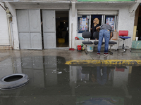 Families are standing outside their flooded homes in Ecatepec, State of Mexico, as a result of the rains during the last few days. (