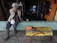 A woman is standing outside her flooded business in Ecatepec, State of Mexico, as a result of the rains during the last few days. (