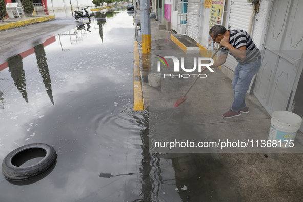 Families are standing outside their flooded homes in Ecatepec, State of Mexico, as a result of the rains during the last few days. 