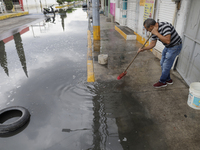 Families are standing outside their flooded homes in Ecatepec, State of Mexico, as a result of the rains during the last few days. (