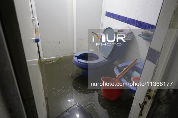 I am viewing an affected bathroom after flooding in Ecatepec, State of Mexico, due to the rains during the last few days. 