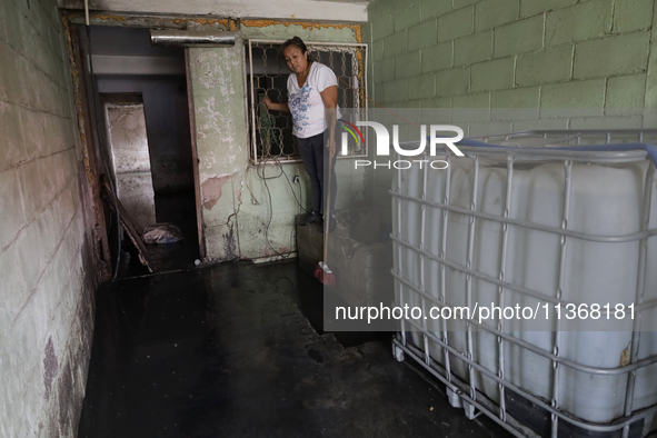 A woman is staying inside her home affected by flooding in Ecatepec, State of Mexico, due to the rains during the last few days. 