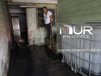 A woman is staying inside her home affected by flooding in Ecatepec, State of Mexico, due to the rains during the last few days. (