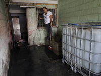 A woman is staying inside her home affected by flooding in Ecatepec, State of Mexico, due to the rains during the last few days. (