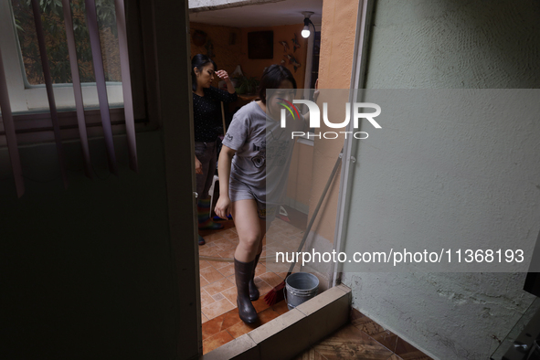 A woman is staying inside her home affected by flooding in Ecatepec, State of Mexico, due to the rains during the last few days. 