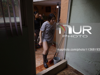 A woman is staying inside her home affected by flooding in Ecatepec, State of Mexico, due to the rains during the last few days. (