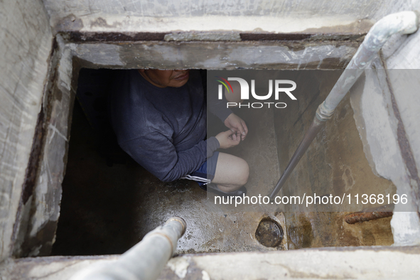 A person is inside a cistern of his home affected by flooding in Ecatepec, State of Mexico, due to the rains during the last few days. 