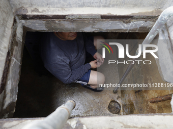 A person is inside a cistern of his home affected by flooding in Ecatepec, State of Mexico, due to the rains during the last few days. (