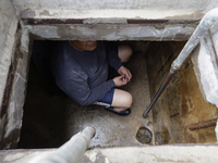 A person is inside a cistern of his home affected by flooding in Ecatepec, State of Mexico, due to the rains during the last few days. (